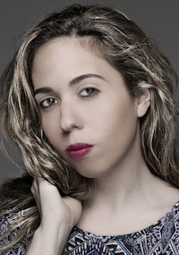 a woman with long hair posing for a photo