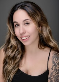 a woman with tattoos posing for a photo